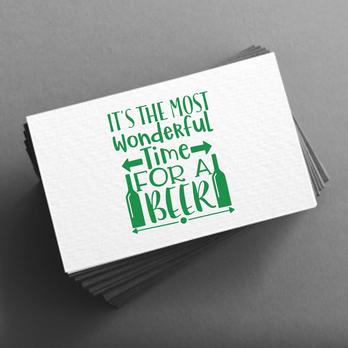 Green beer-themed stamp design with bottle icons and Its the most wonderful time for a beer on a white card.