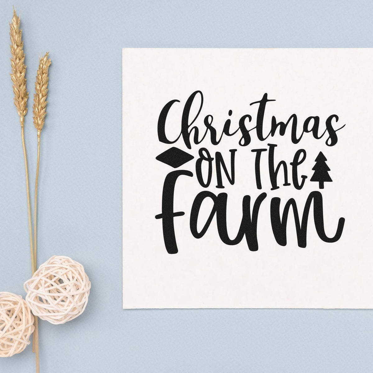 Black Christmas on the Farm stamp and seal on white card, with wheat stalks on a light blue background.