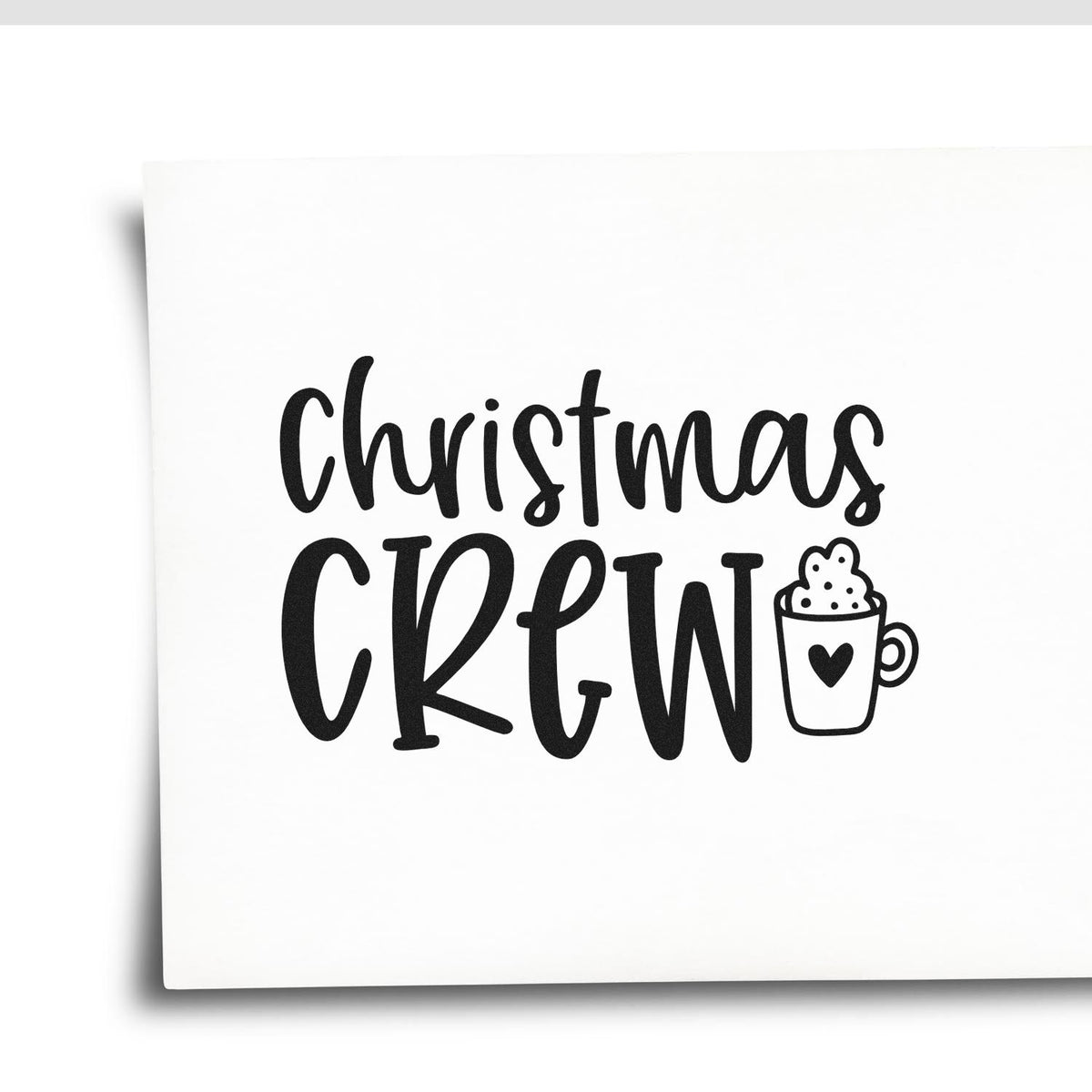 Black Christmas Crew stamp and seal design with a mug and heart on white paper.