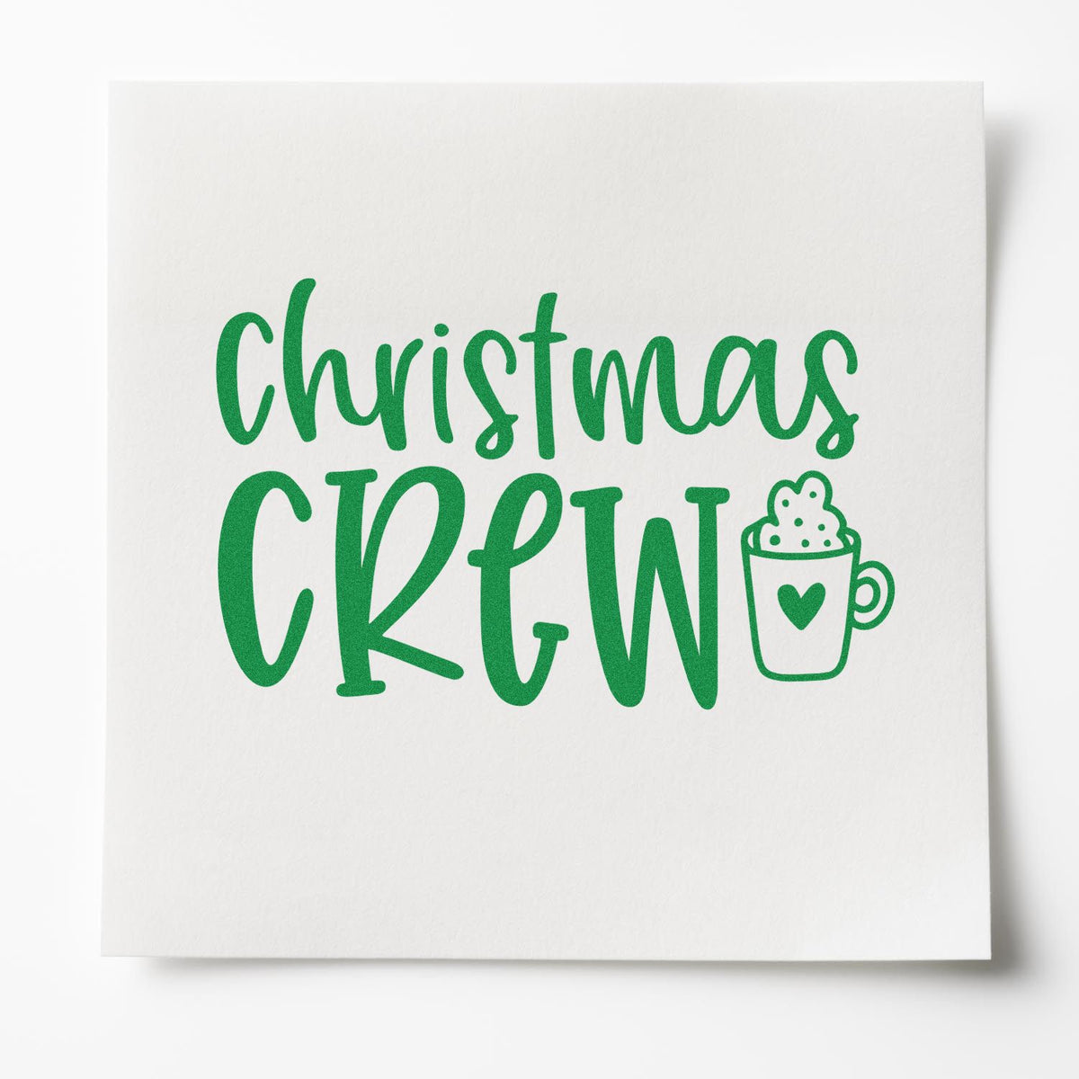 Green Christmas Crew stamp seal in bright green with mug icon on a white textured background.