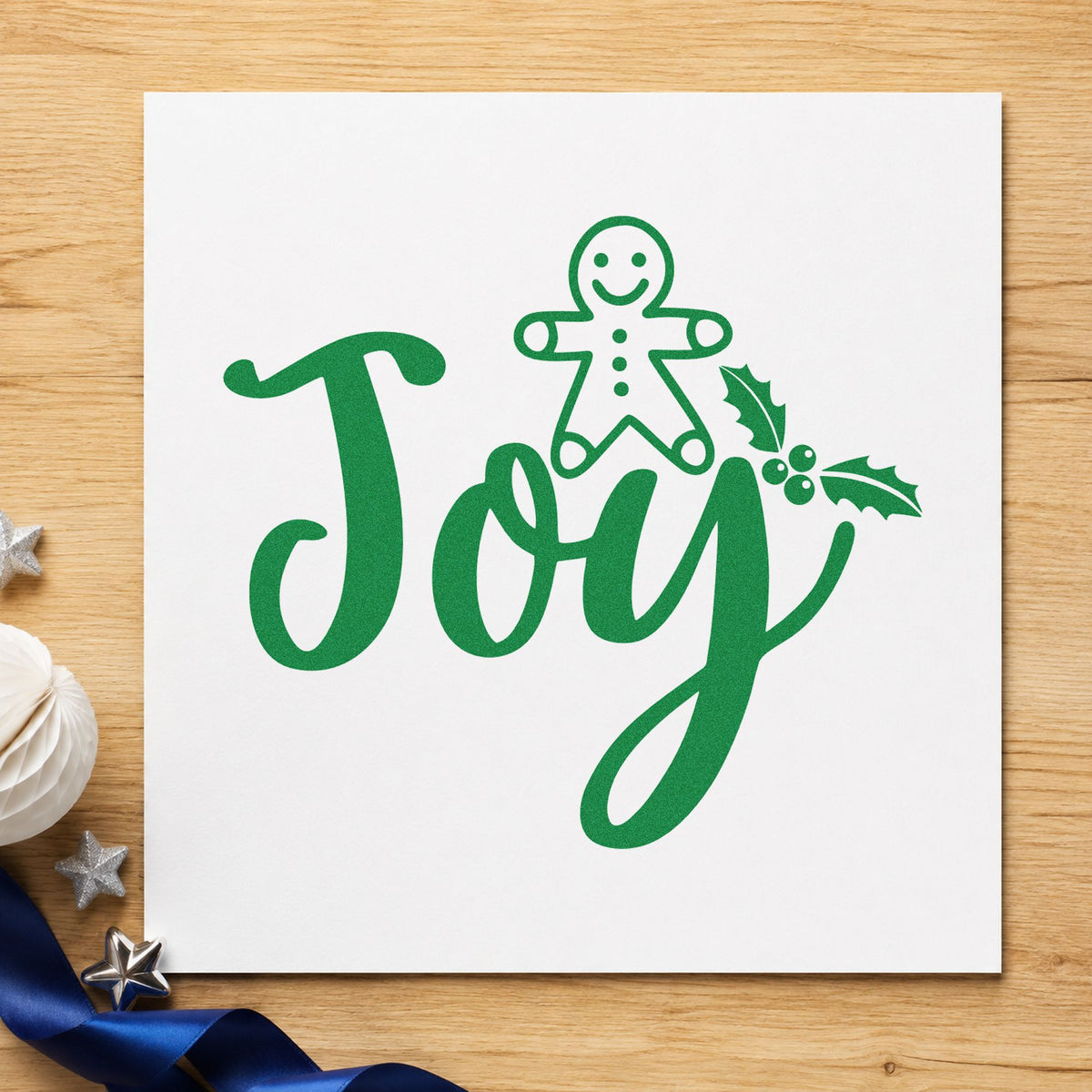Joy Gingerbread Holly Lettering craft stamp imprint in green ink on a handmade project, one idea being figure cookie tags.