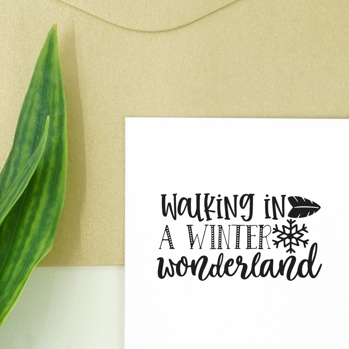 Black winter-themed stamp and seal on white card, reading Walking in a Winter Wonderland, with snowflake and leaf accents.
