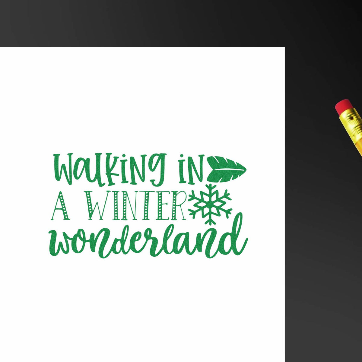 Green stamp design reading Walking in a Winter Wonderland with snowflake on white paper, beside a gold-and-red seal tool.