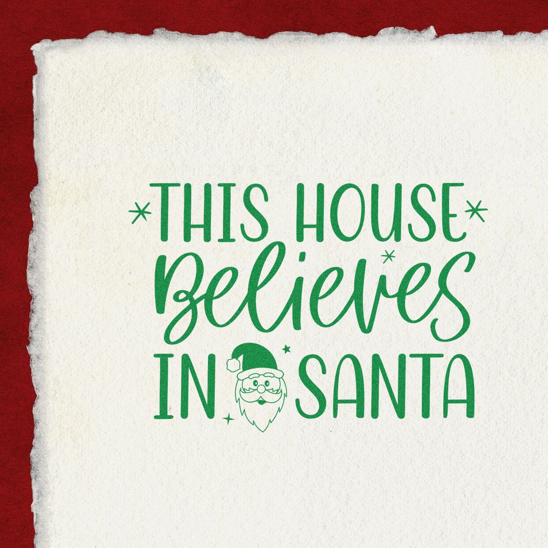 Green holiday stamp and Santa seal on textured white paper with red background, reading This house believes in Santa.