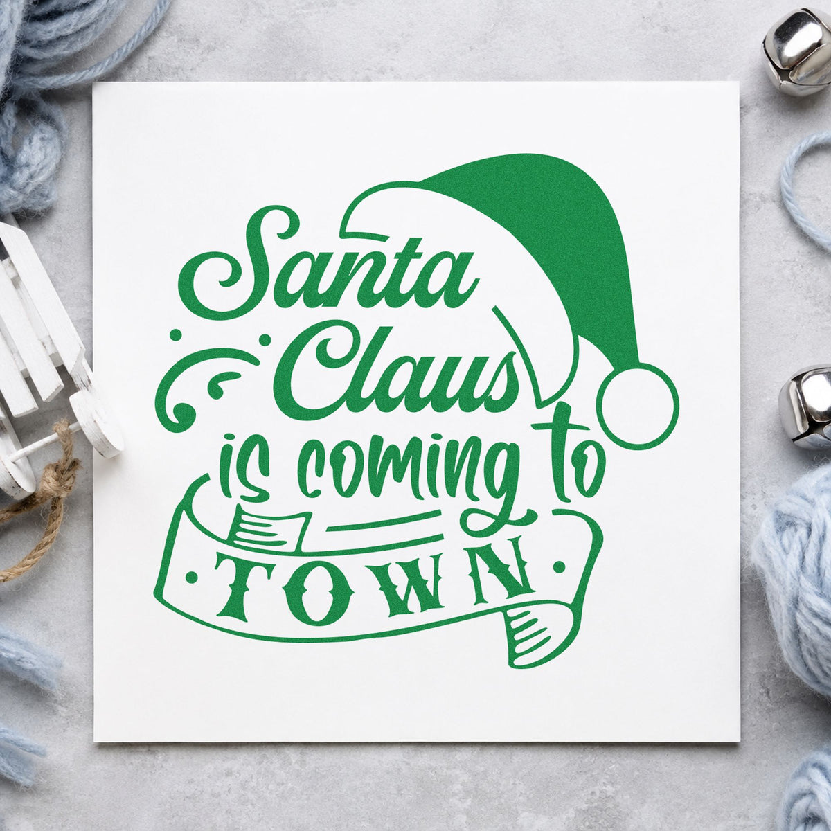 Santa Claus Coming To Town craft stamp imprint in green ink on a handmade project, one idea being queue number tags.