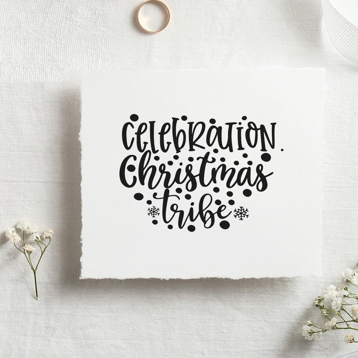 Black Celebration Christmas Tribe stamp design on white textured paper, with snowflakes, dots and a seal-style layout.