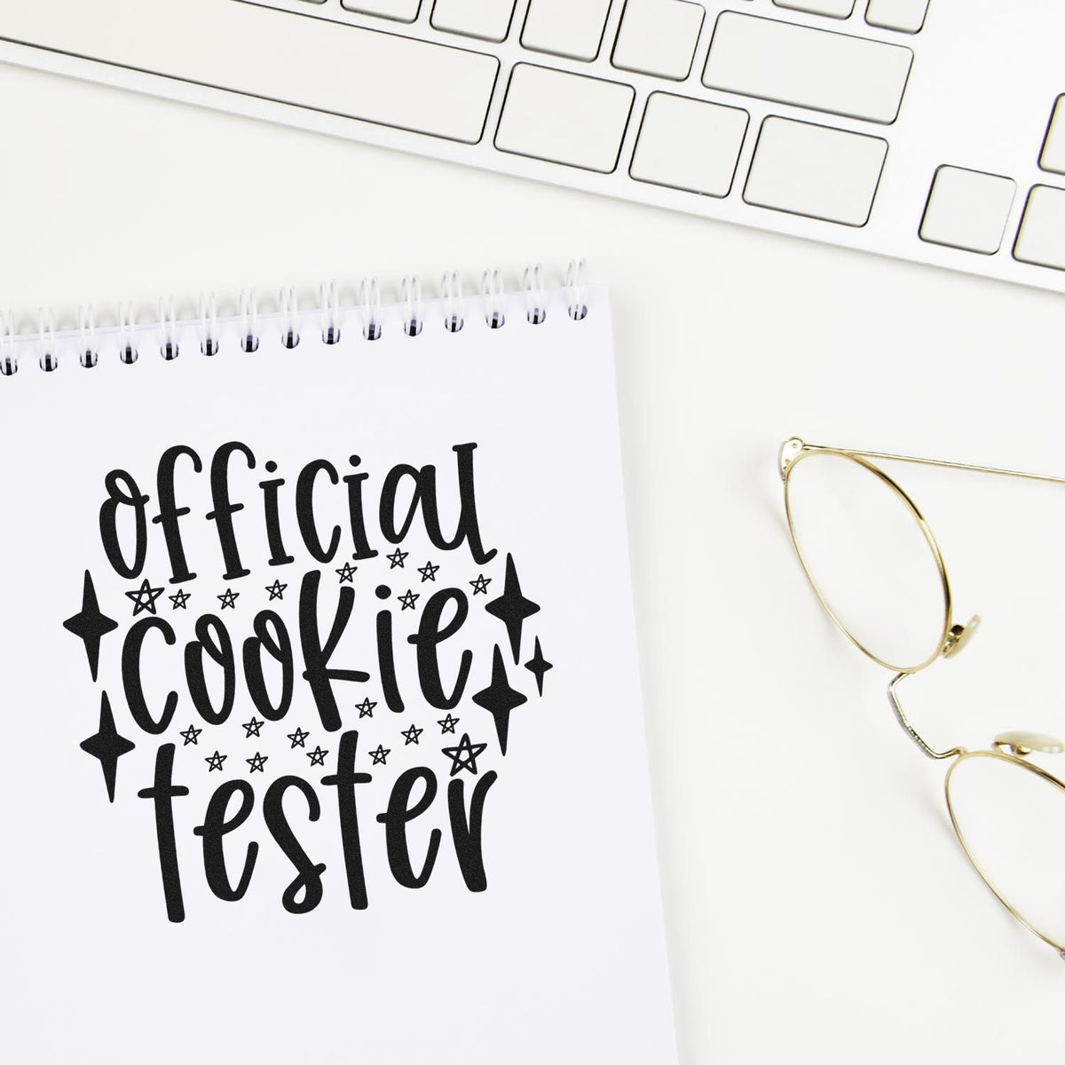 Official Cookie Tester Star Accents Slim Pre-Inked Stamp imprint stamped in black ink. The words "Official cookie tester" are surrounded by stars and sparkling diamond shapes.