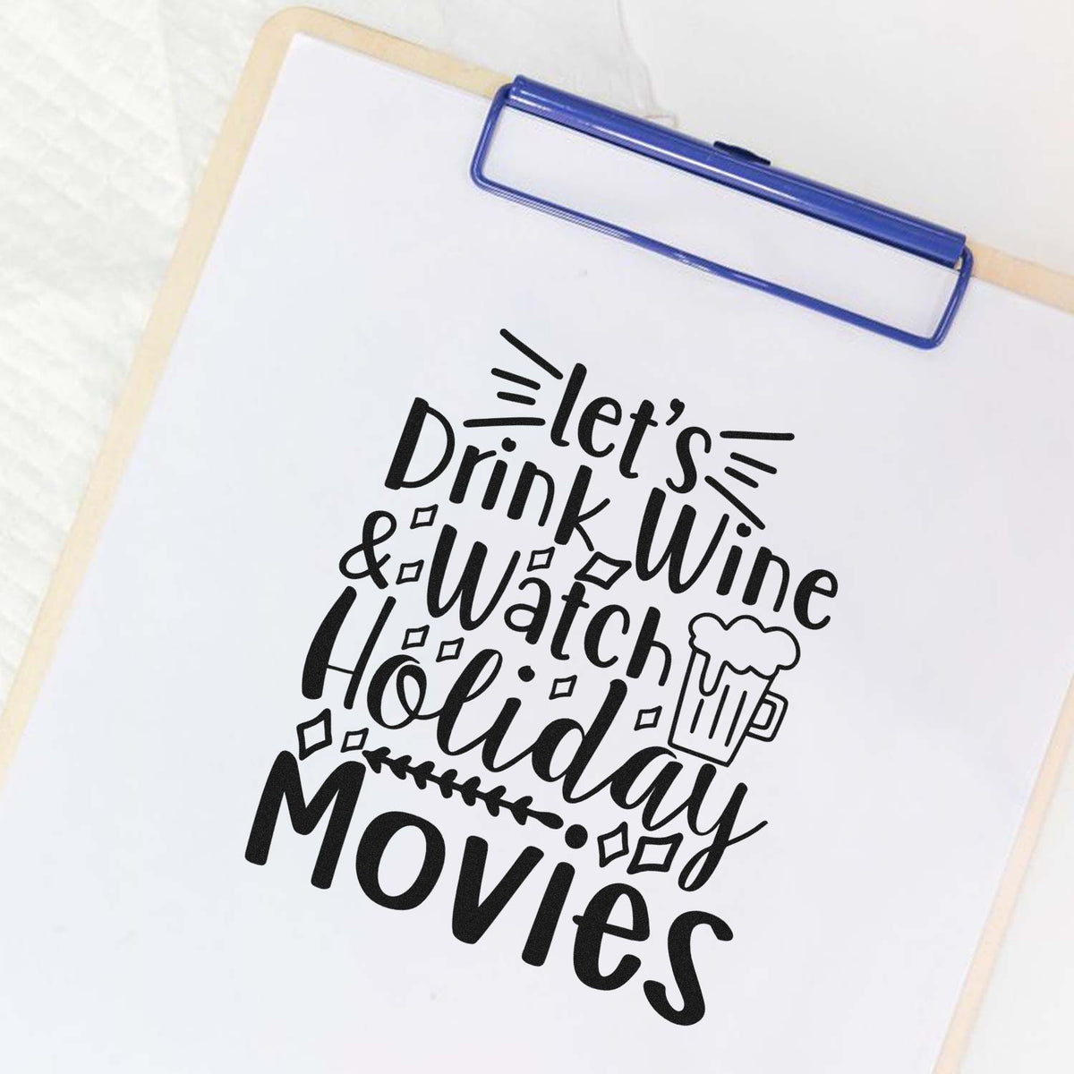Black holiday stamp design on white clipboard, reading Lets Drink Wine & Watch Holiday Movies with beer mug icon.