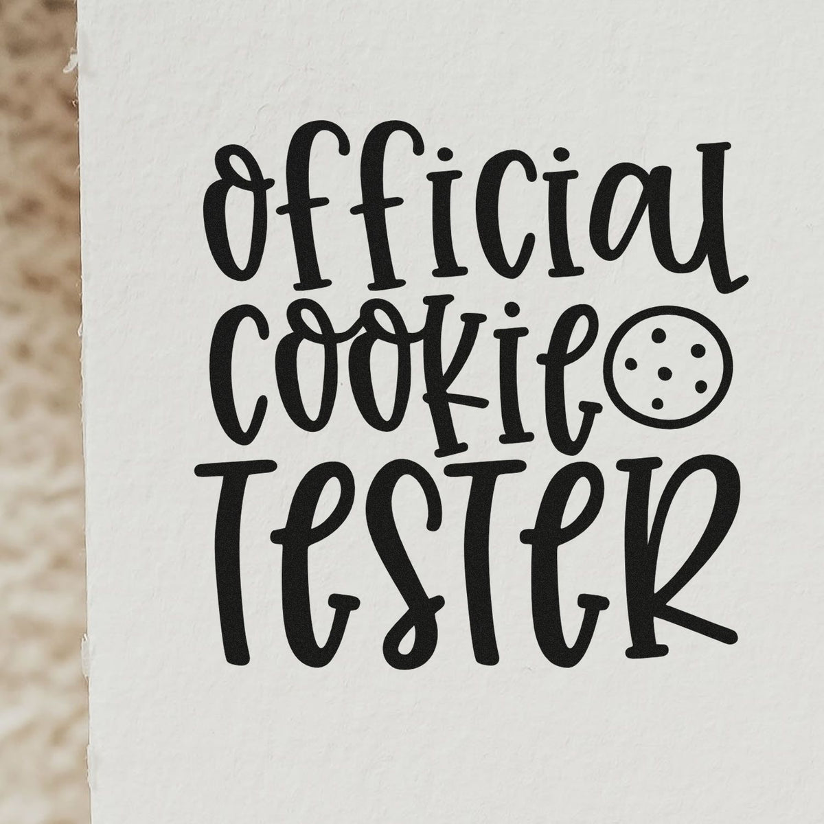 Round Cookie With Official Cookie Tester Wood-Mounted Rubber Stamp imprint stamped in black ink. The words "Official cookie tester" appear in tall lettering beside a round cookie.
