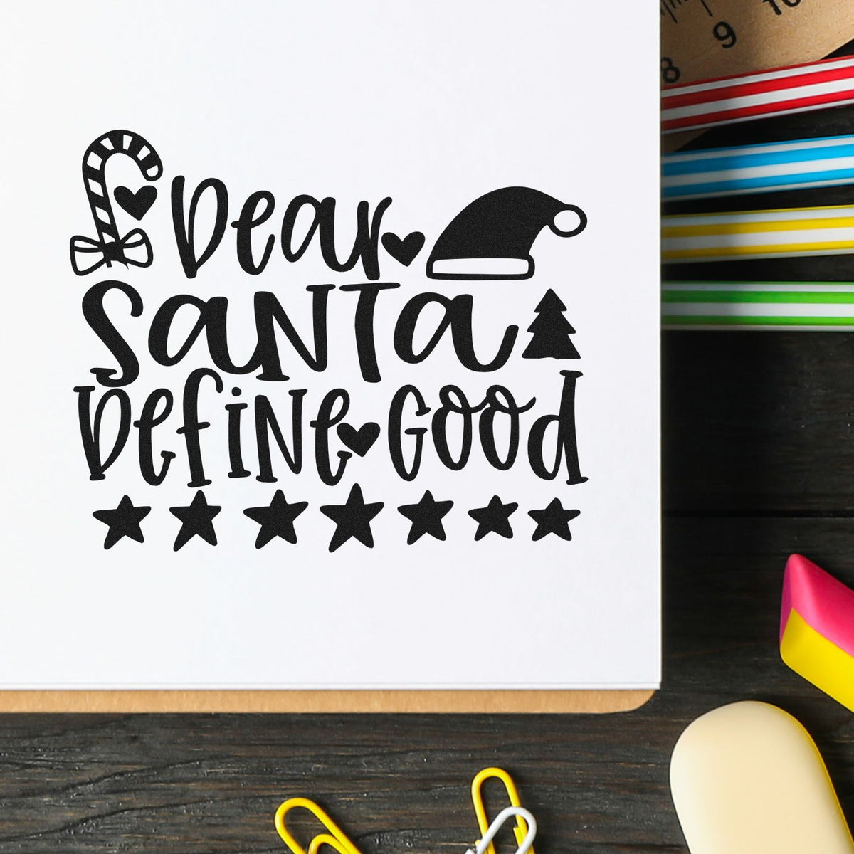 Black Christmas stamp and seal design with candy cane, Santa hat, tree and stars on white paper.