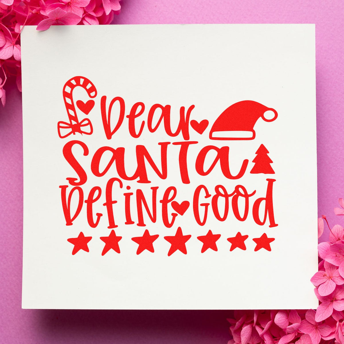Red holiday stamp and seal on white card with candy cane, Santa hat, tree, stars, and Dear Santa Defined Good text.