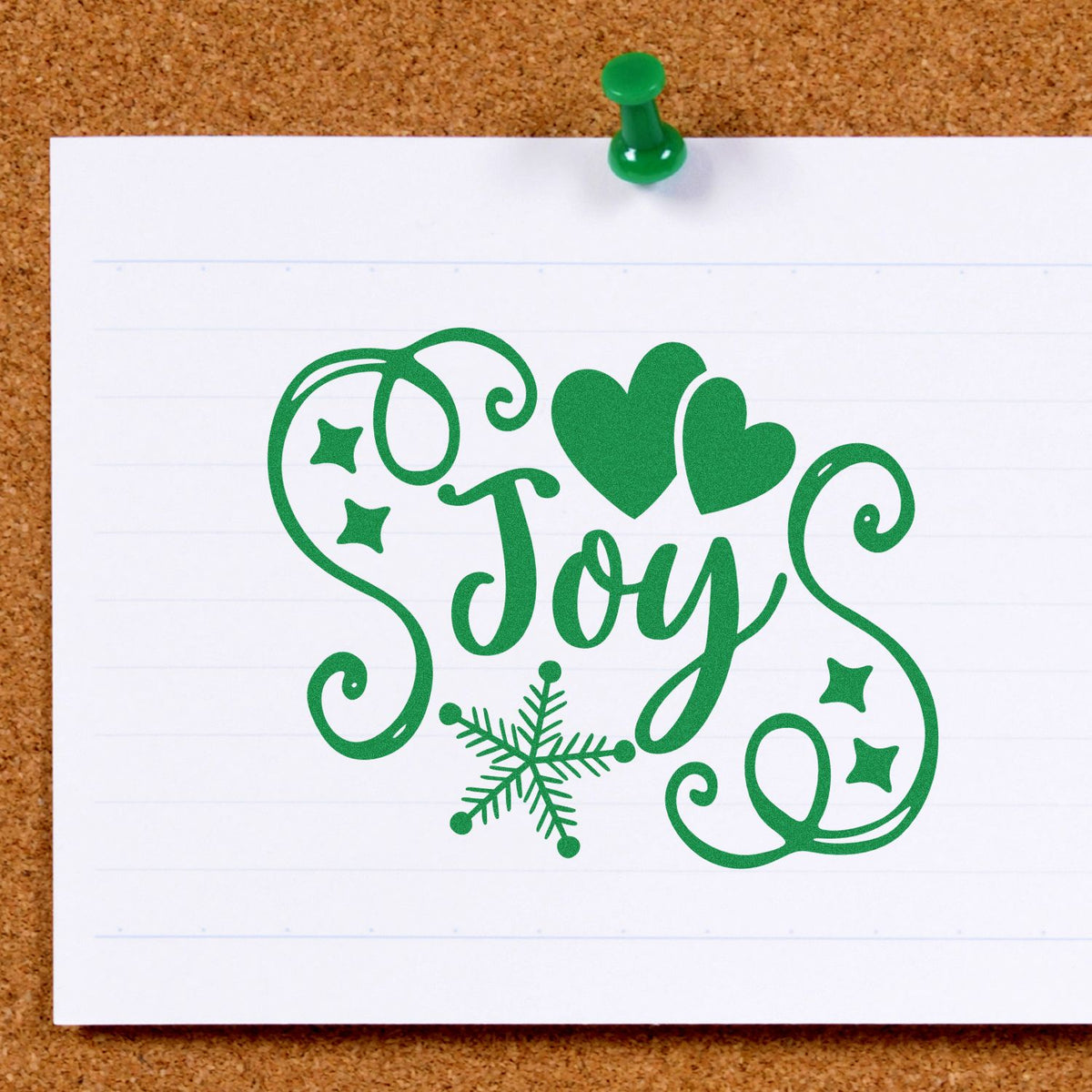 Green Joy holiday stamp seal in green with hearts, stars, and a snowflake on white paper.