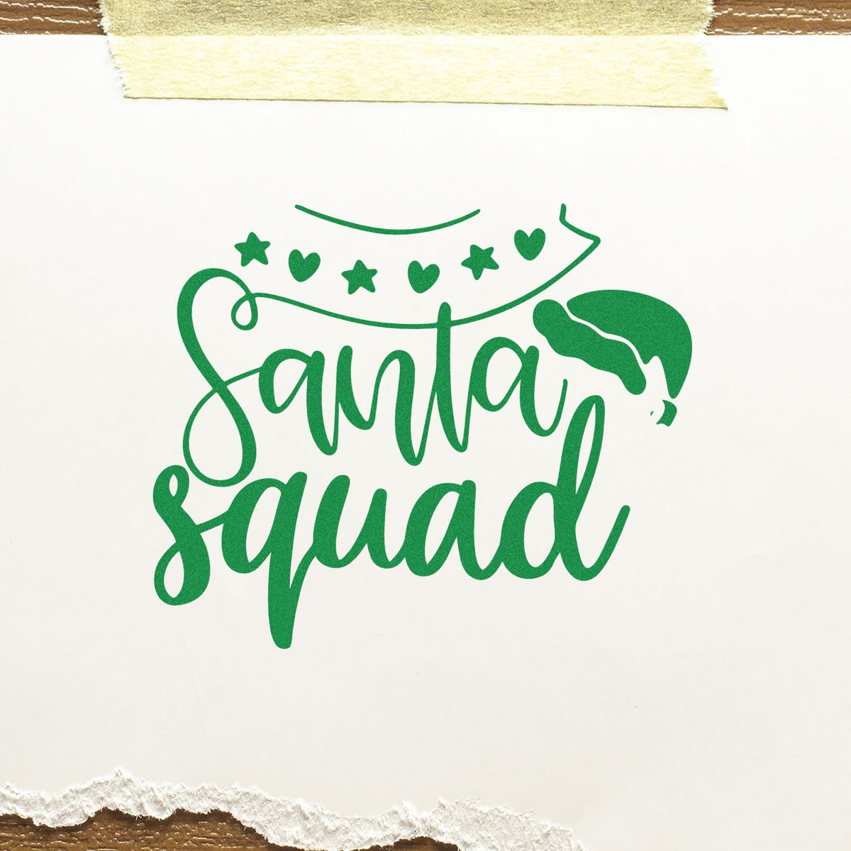 Green Santa Squad stamp seal with stars, hearts and Santa hat on white paper