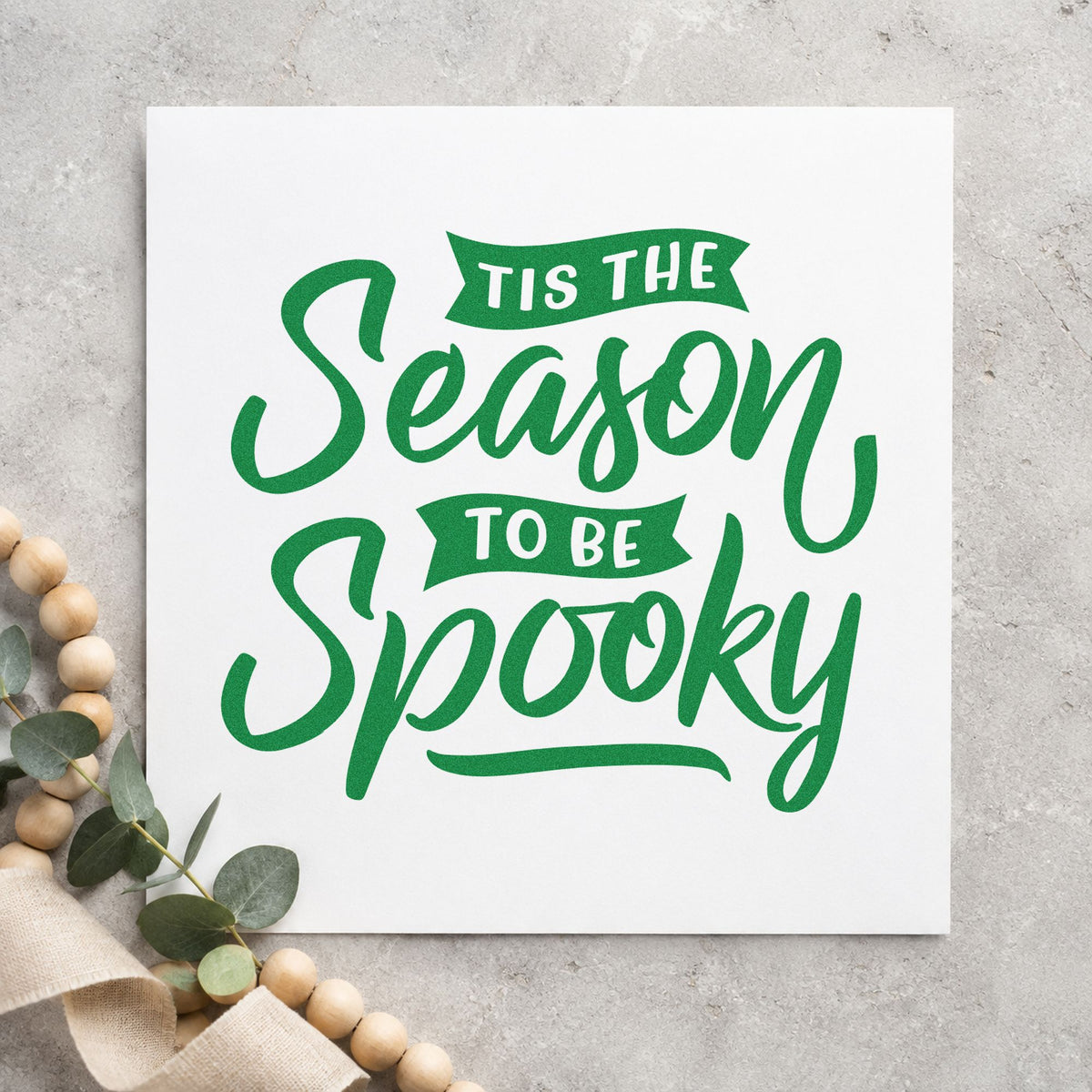 Season To Be Spooky craft stamp imprinted in green ink on paper, a design suited to framed porch post.