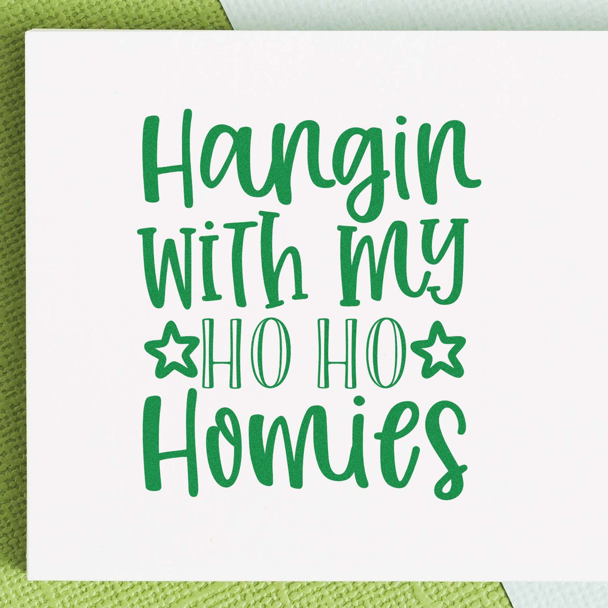 Green holiday stamp and seal design with Hangin with my Ho Ho Homies in green on a white card with stars.