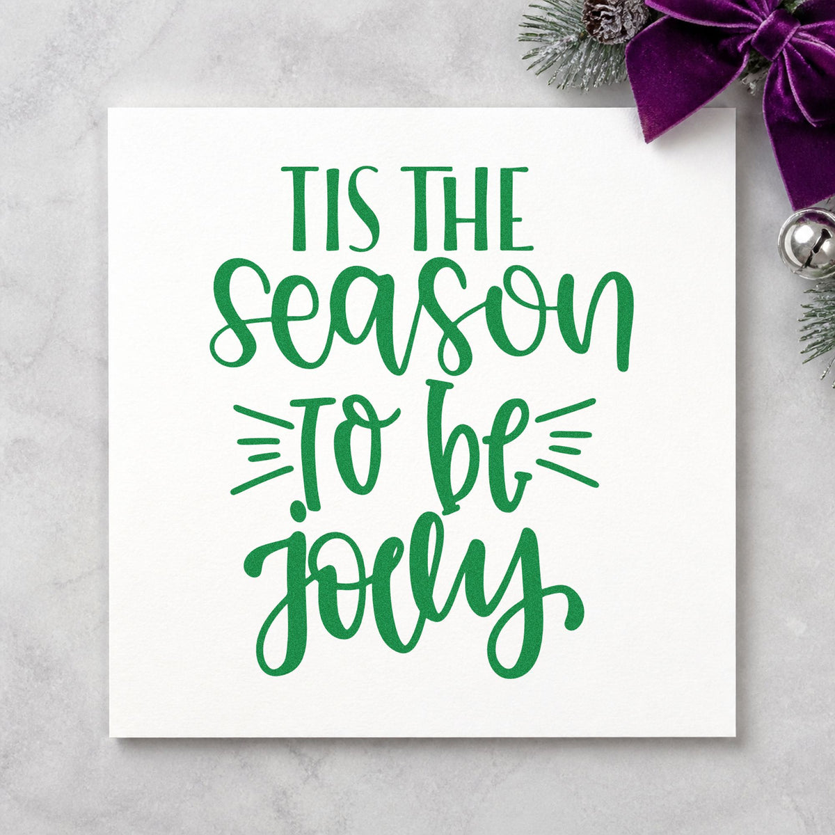 Tis The Season Jolly craft stamp imprint in green ink on a handmade project, one idea being stressed word tags.