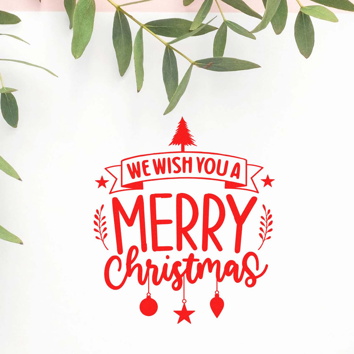 Red Merry Christmas stamp and seal with We Wish You a Merry Christmas text, ornaments, on a white background with green leaves.