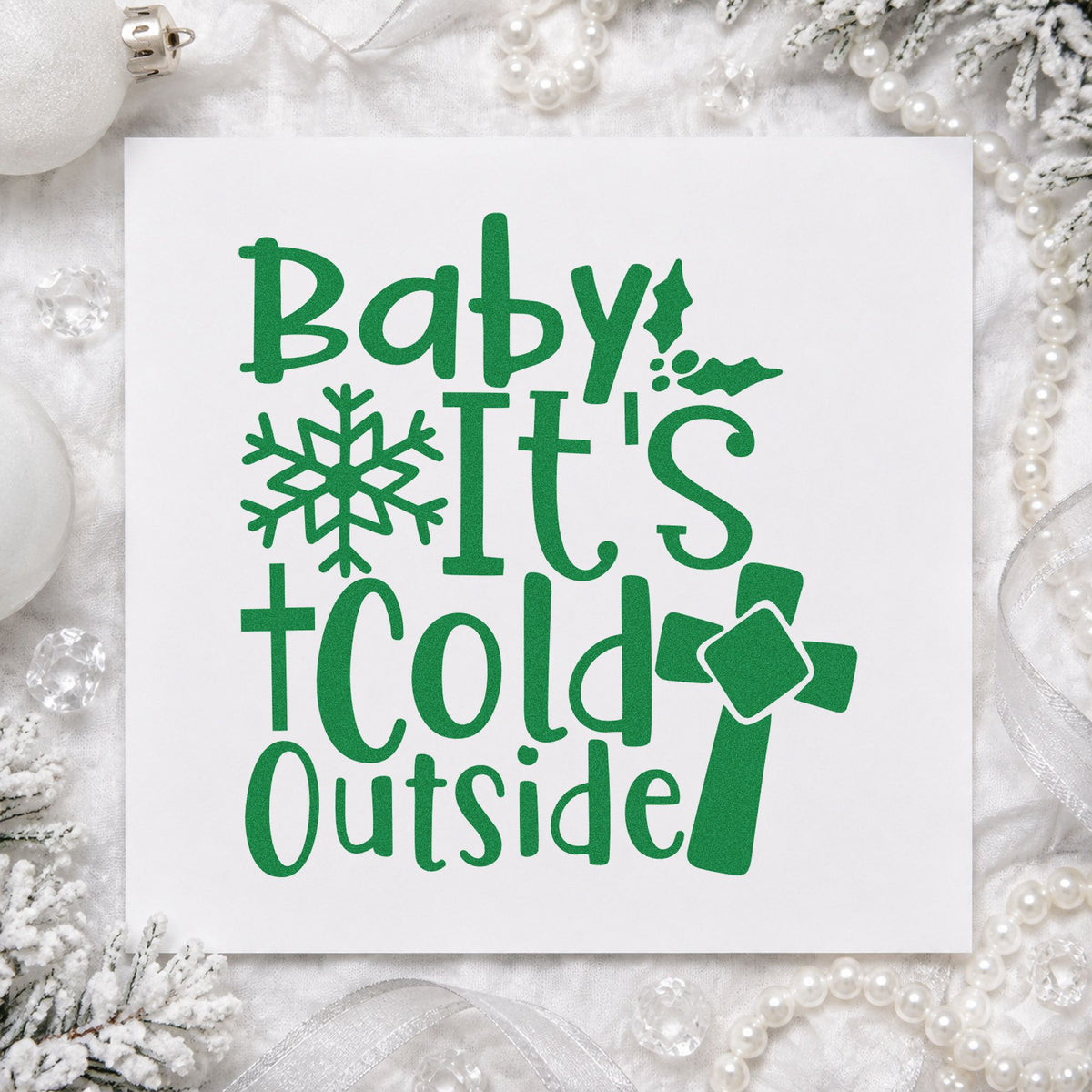Baby It's Cold Outside Cross craft stamp imprint in green ink on a handmade project, one idea being outreach note cards.