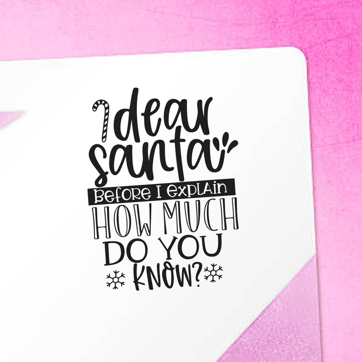 White stamp seal with black Dear Santa text on pink background, featuring snowflakes and playful holiday lettering.