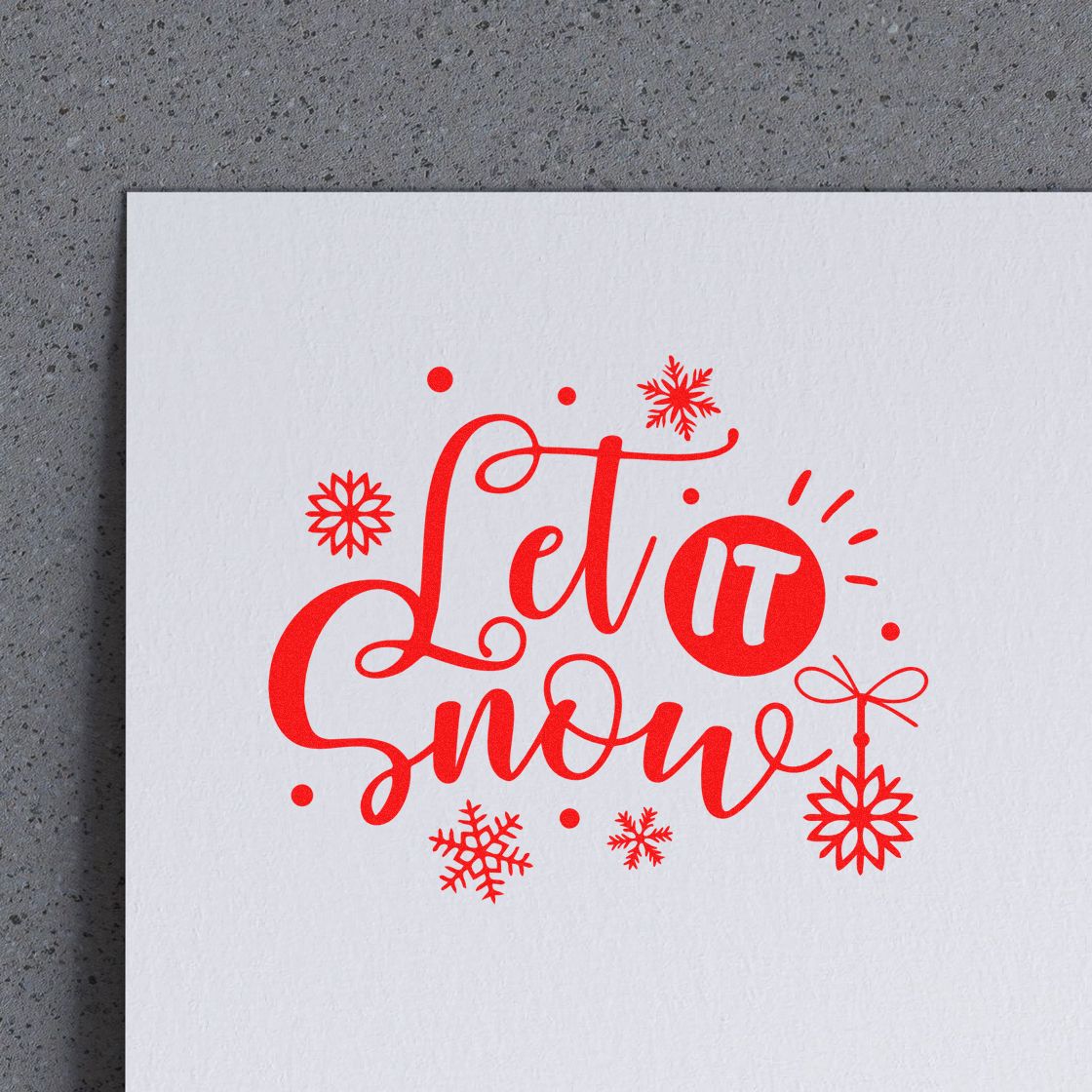 Red Let it Snow stamp seal with snowflakes on white paper
