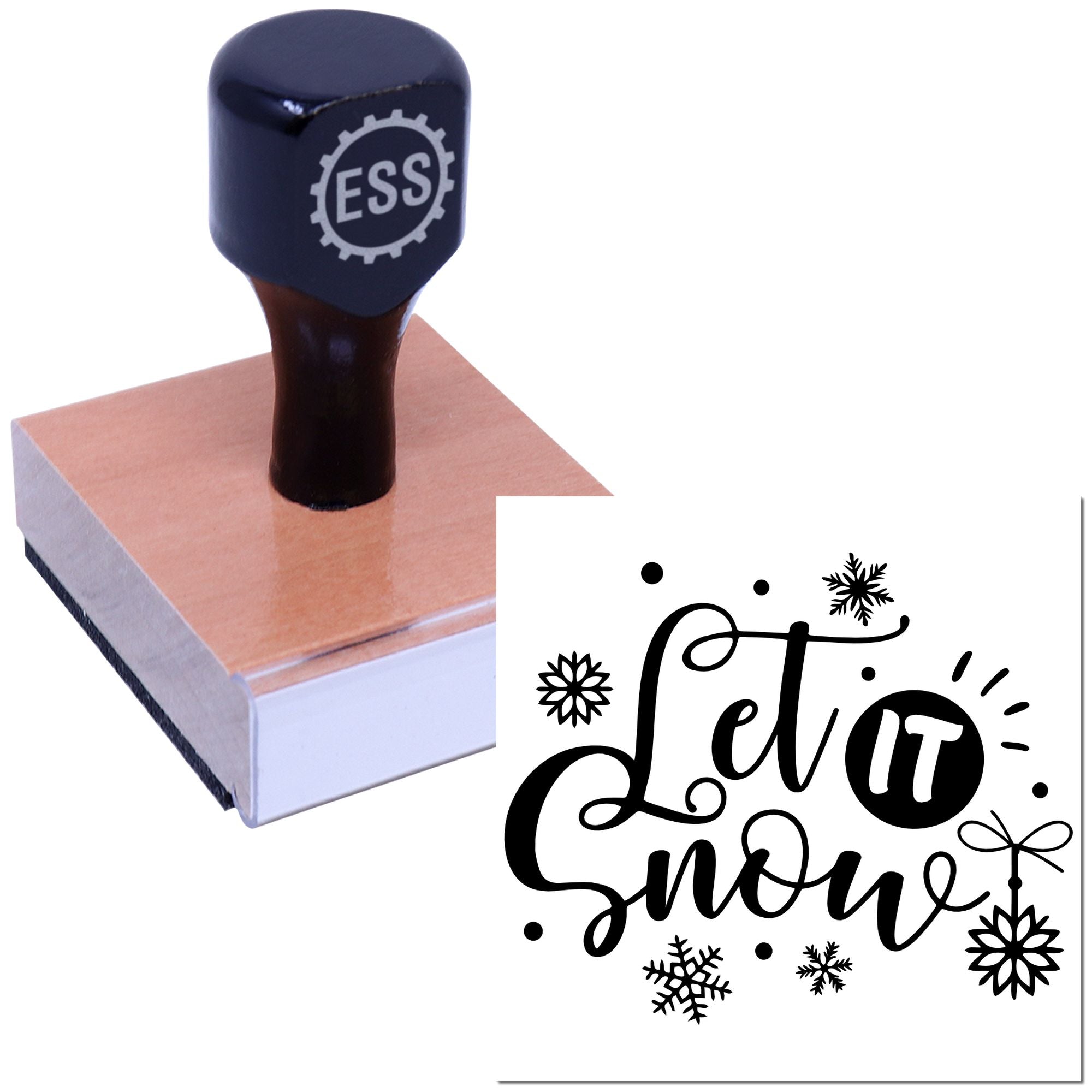 Dark navy rubber stamp on a peach wooden block, making a black Let it snow snowflake seal impression