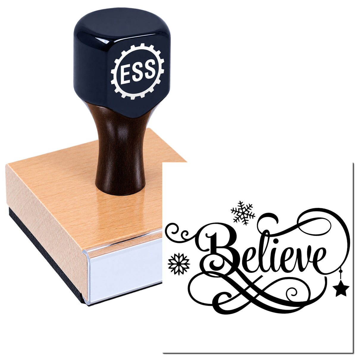 Dark blue ESS stamp on wooden block with black "Believe" seal design and snowflake accents