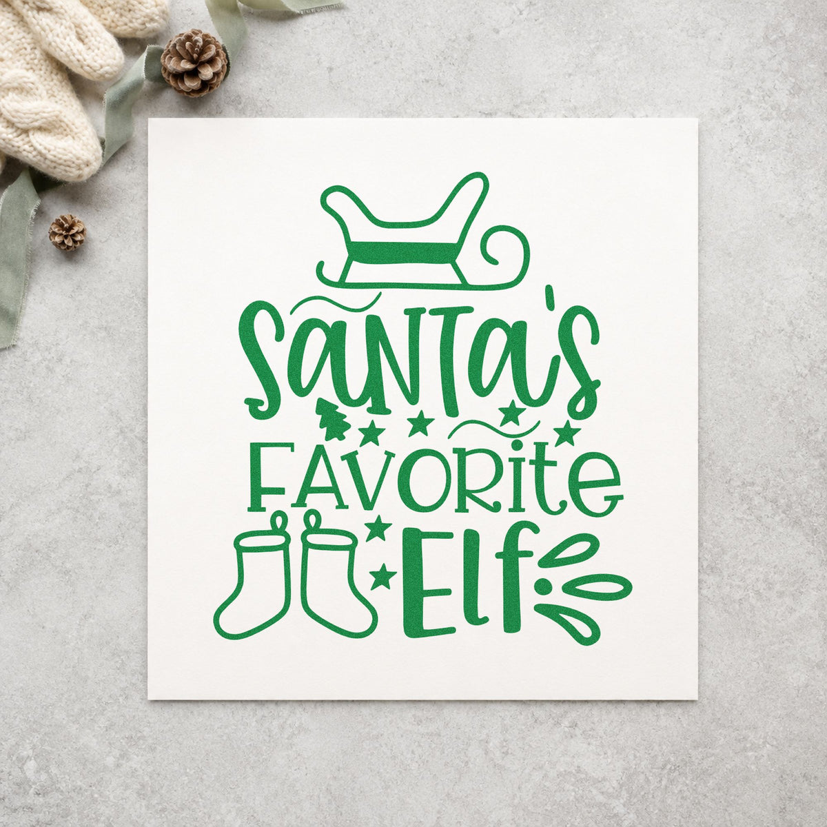 Santa's Favorite Elf Stockings craft stamp imprint in green ink on a handmade project, one idea being named stocking tags.