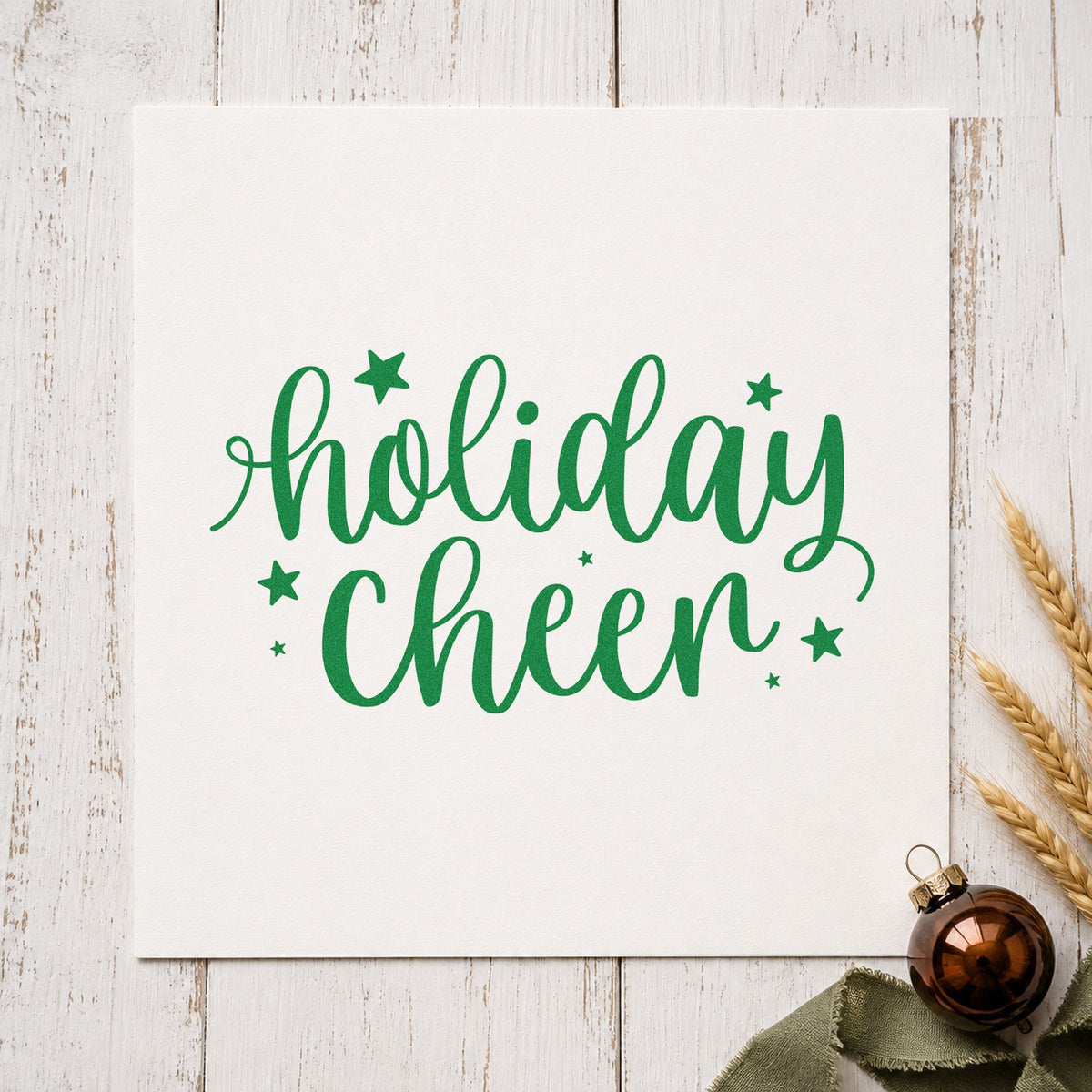 Holiday Cheer Star Lettering craft stamp imprint in green ink on a handmade project, one idea being place marker slips.