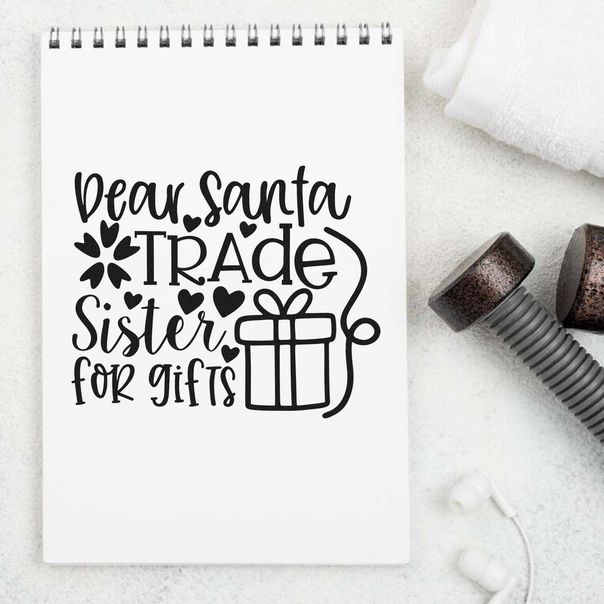 Black stamp and seal design on white notebook: Dear Santa, Trade Sister for Gifts with hearts and gift icon.