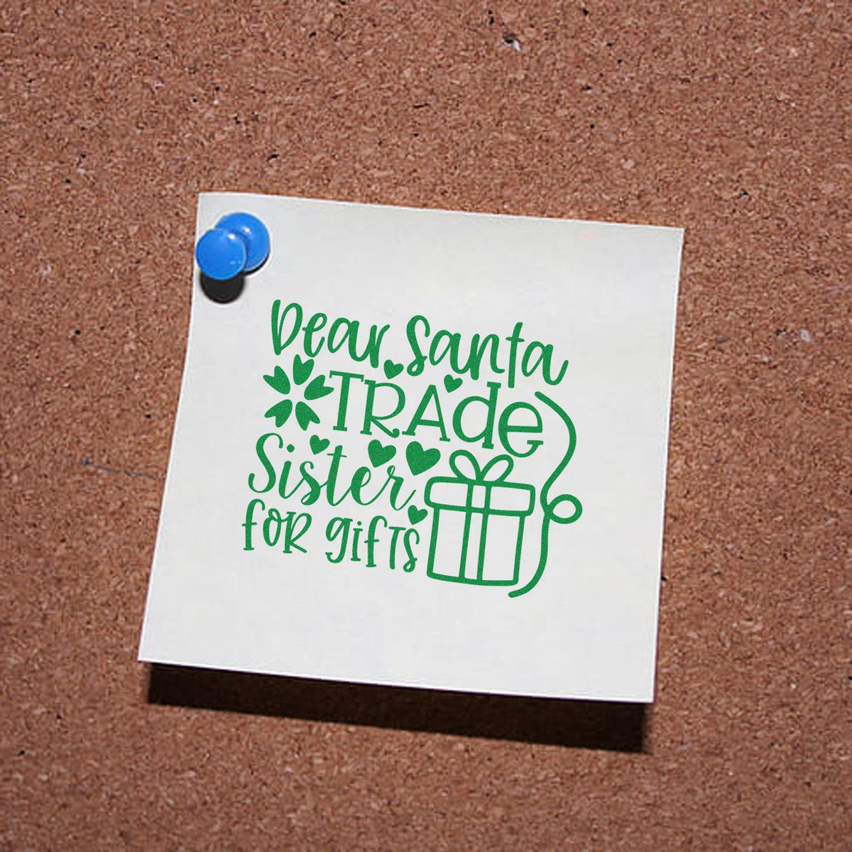 Green Dear Santa Trade Sister for gifts stamp and seal design on white paper, pinned with a blue pushpin.