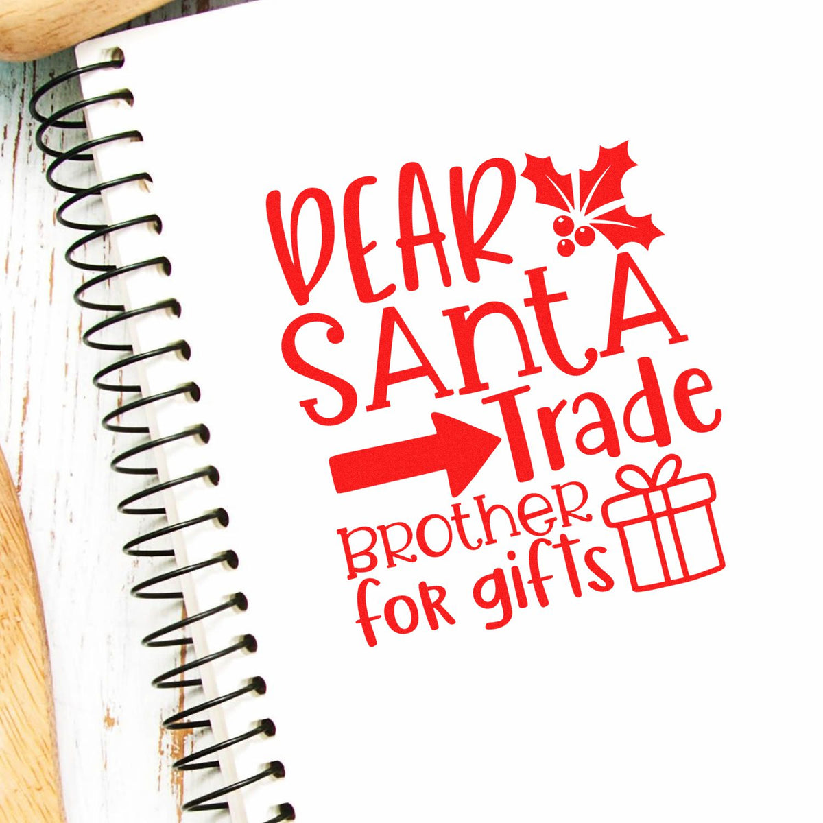 Red holiday stamp and seal reading Dear Santa, trade brother for gifts with holly and gift icon on white paper.