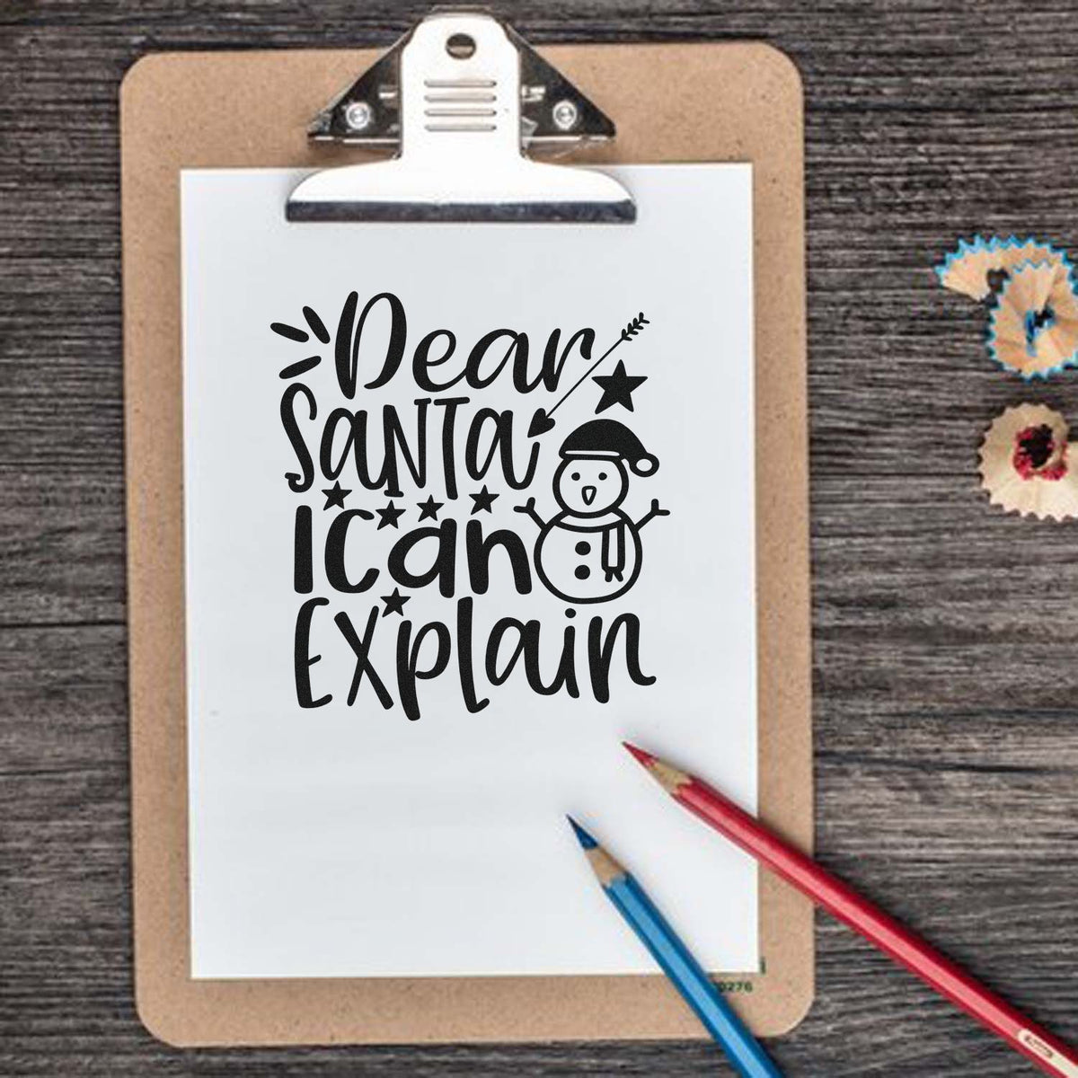 Holiday stamp and seal design: black Dear Santa I can explain text, snowman, on white clipboard with red and blue pencils.