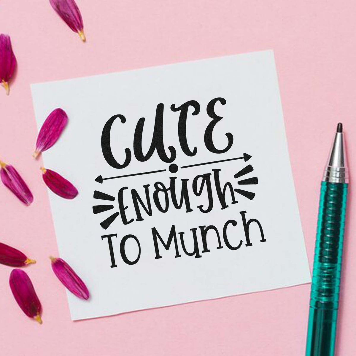 Custom stamp and seal design reading Cute Enough to Munch on white card, pink background with magenta petals and teal tool.