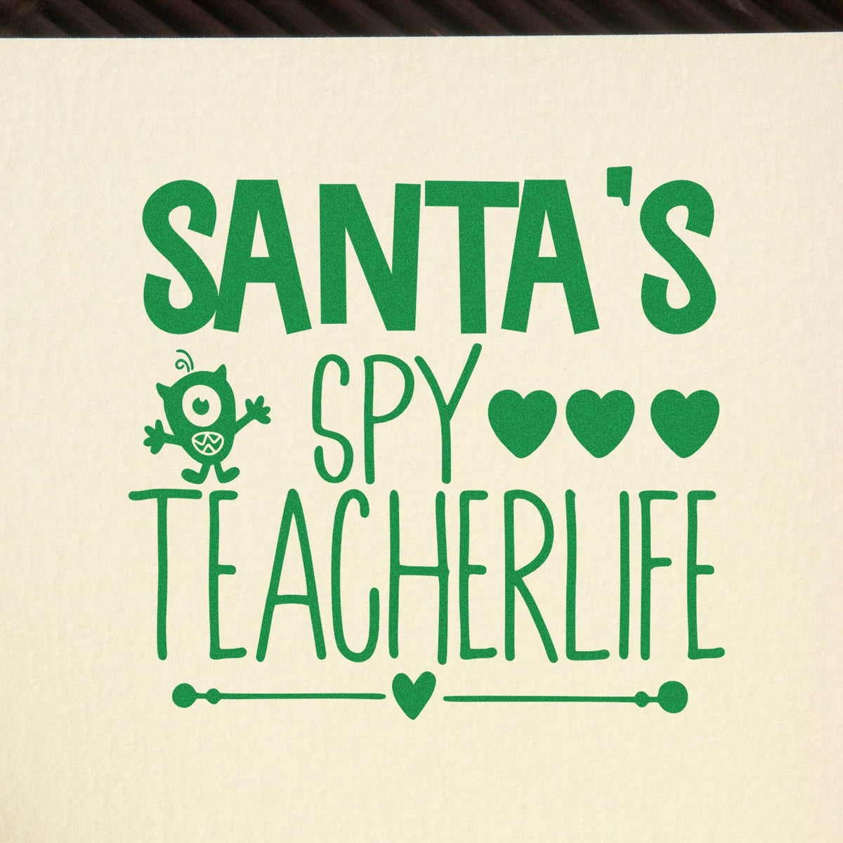 Green Santas Spy Teacher Life stamp-and-seal design on cream canvas, with hearts and a cute monster.