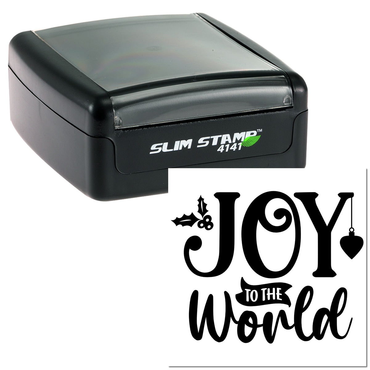 Black slim self-inking stamp and holiday seal design with bold black JOY TO THE WORLD lettering, holly, and ornament.
