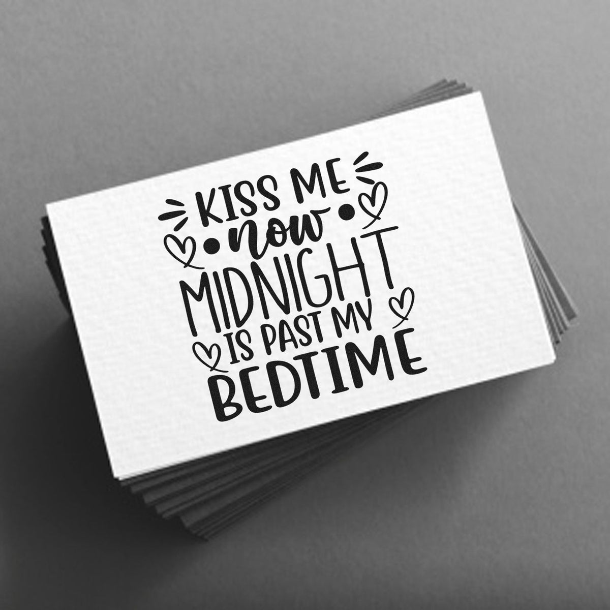 Black custom stamp and seal on white card, with hand-lettered Kiss me now, midnight is past my bedtime and hearts on gray.