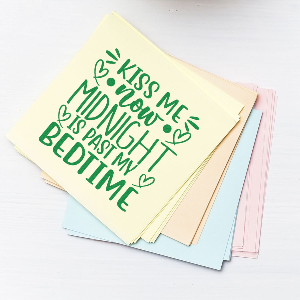 Pastel stamp-and-seal cards with green Kiss me now, midnight is past my bedtime lettering and hearts on stacked sheets.