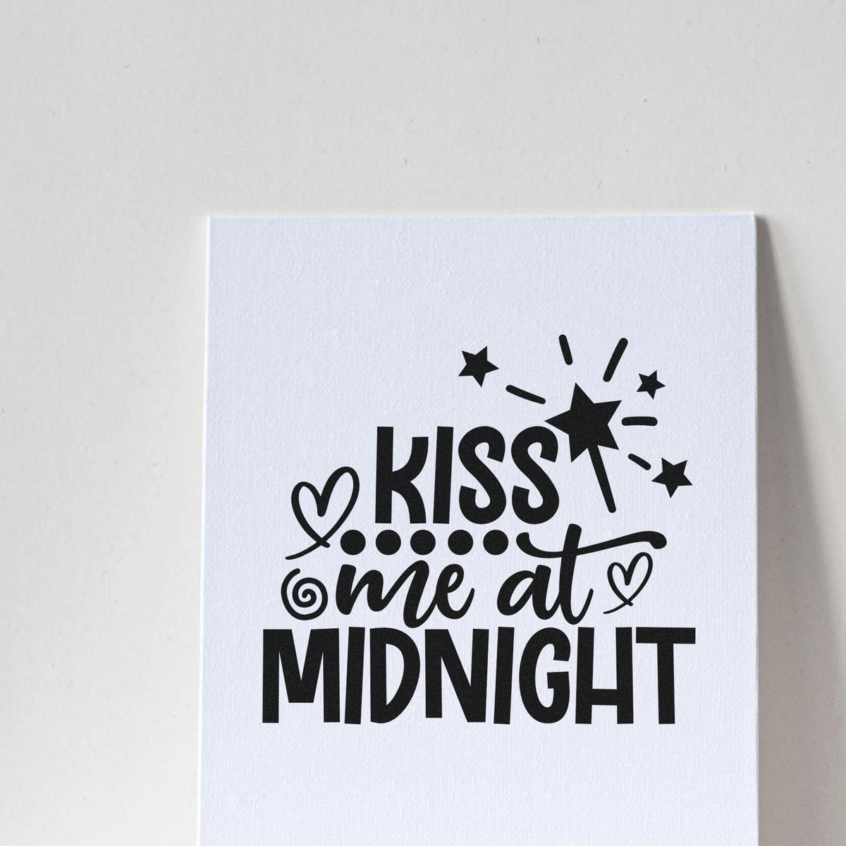 Black Kiss me at Midnight stamp design with stars and hearts on a white seal card.