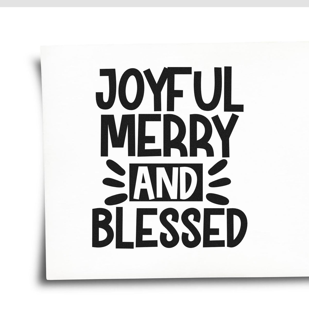 Black JOYFUL MERRY AND BLESSED stamp and seal design on a white square card with bold decorative lettering.