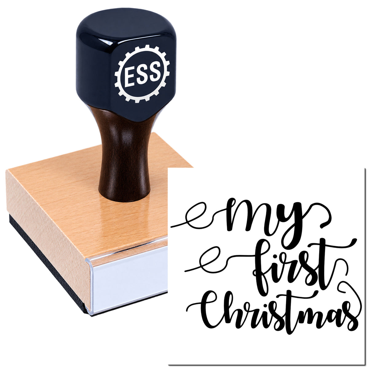 Black custom stamp on a wooden block with ESS logo, featuring "my first Christmas" script in bold black on white.