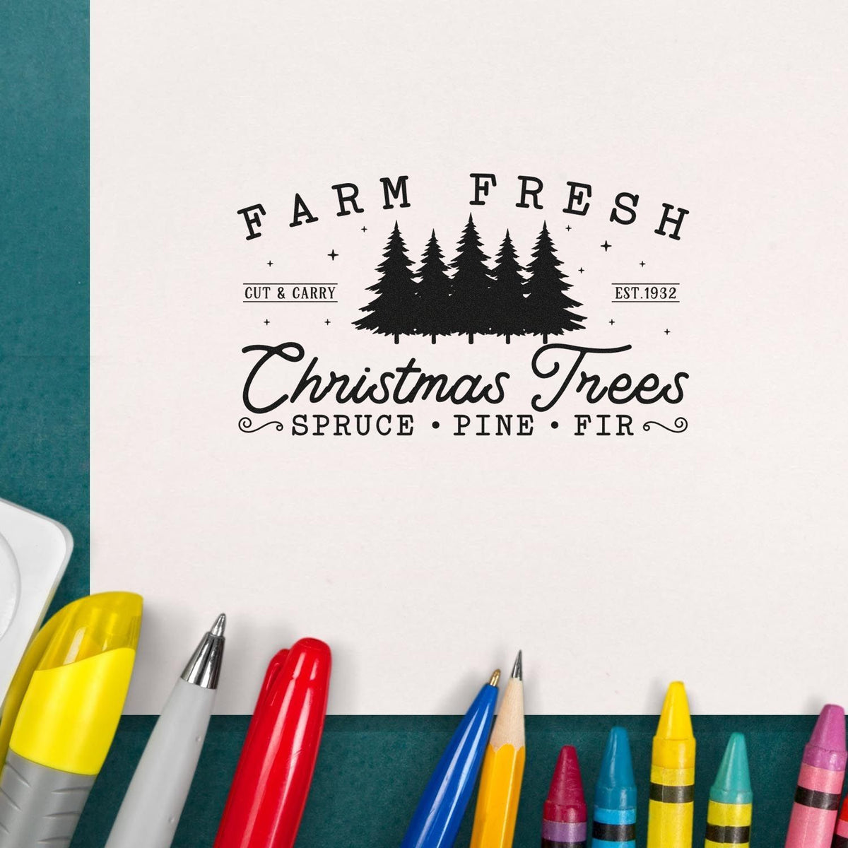 Black Farm Fresh Christmas Trees custom stamp/seal on white paper, with teal background and colorful pens.