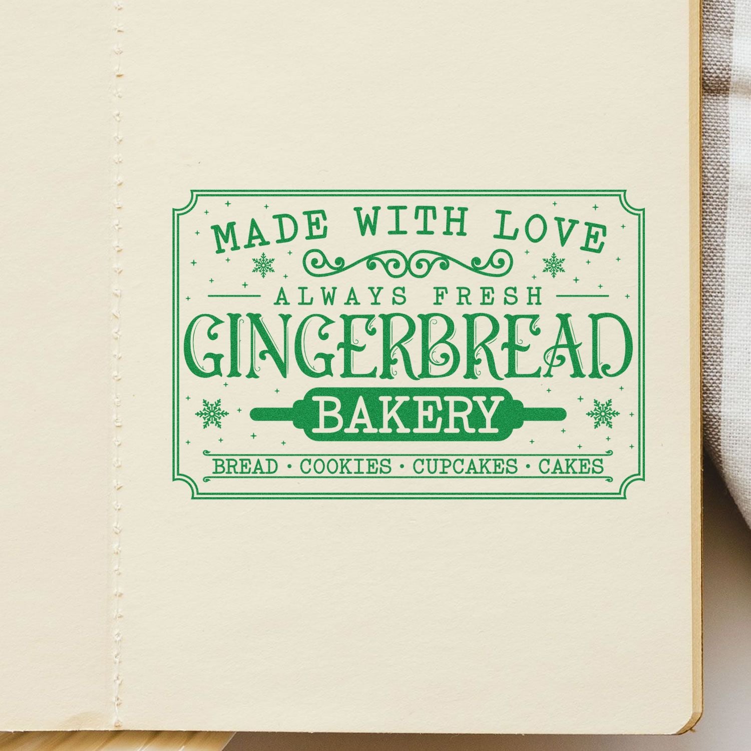 Green vintage bakery stamp seal on cream paper, reading Made with Love, Always Fresh, and Gingerbread Bakery.
