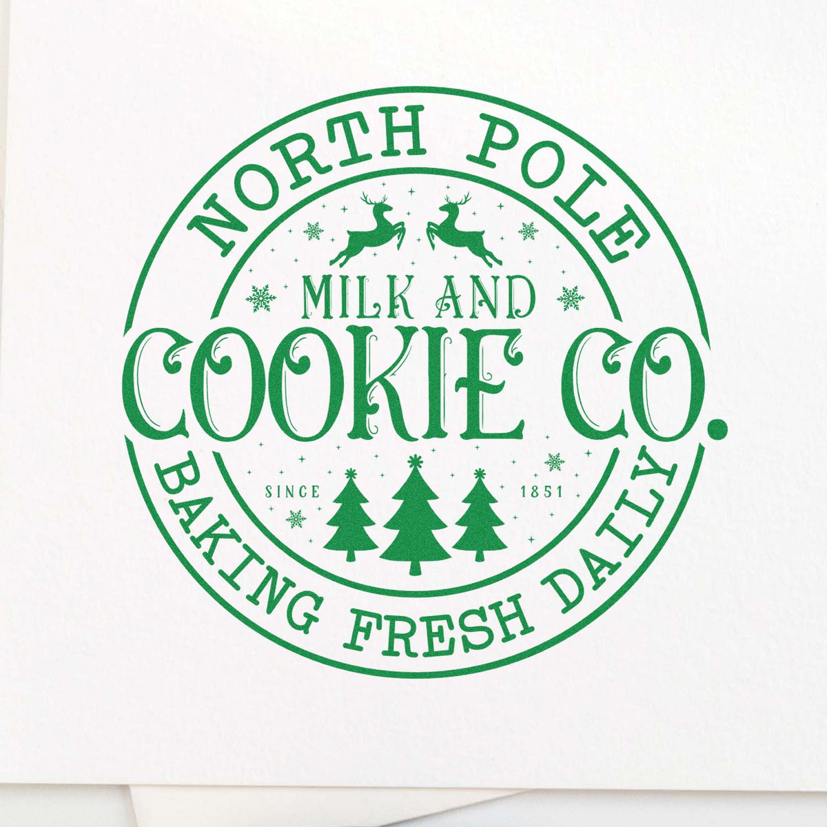 Green circular stamp seal for North Pole Cookie Co., with reindeer, pine trees, and Baking Fresh Daily text in green.