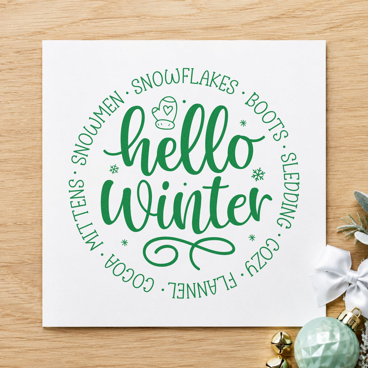 Hello Winter Circular Words craft stamp imprint in green ink on a handmade project, one idea being vocabulary gift tags.