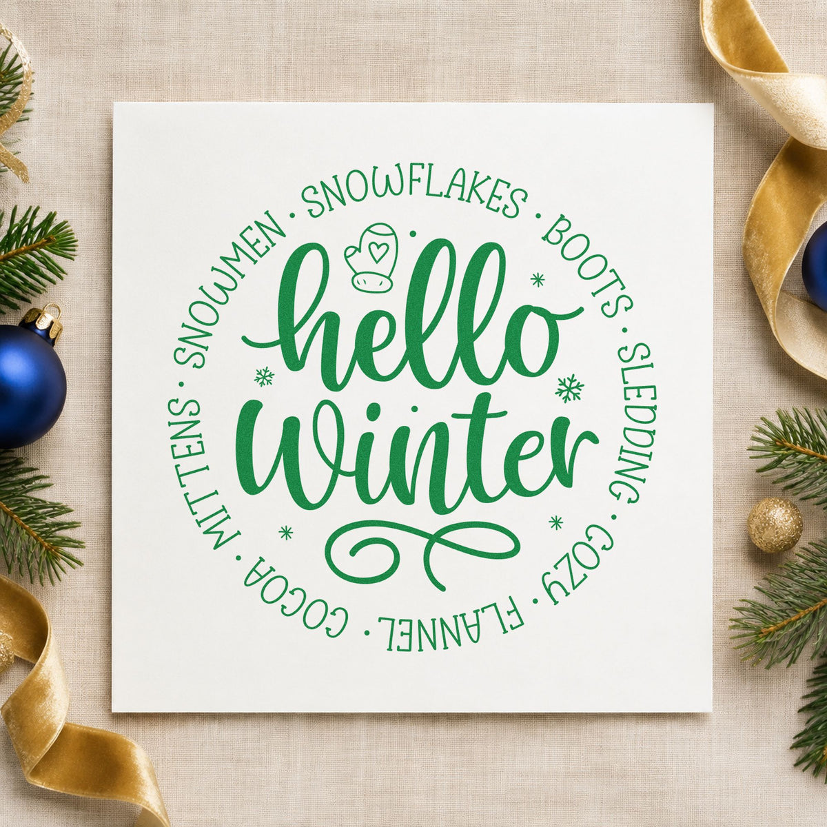 Hello Winter Circular Words craft stamp imprinted in green ink on paper, a design suited to framed round mat.