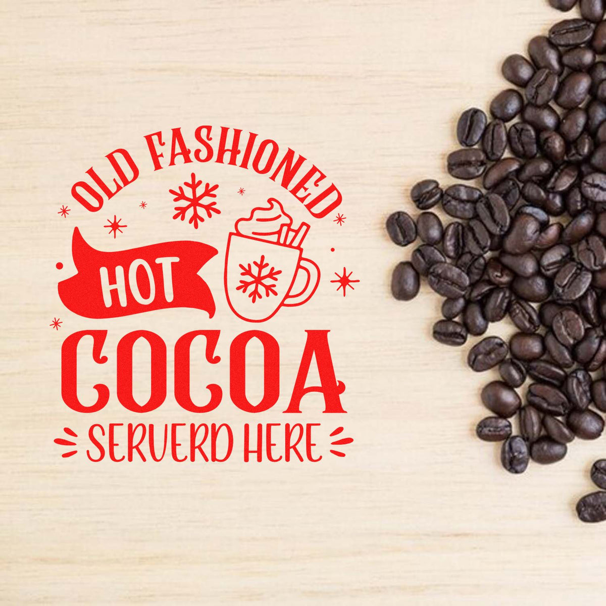Red hot cocoa stamp seal with mug and snowflakes on a light wood background, beside dark coffee beans.