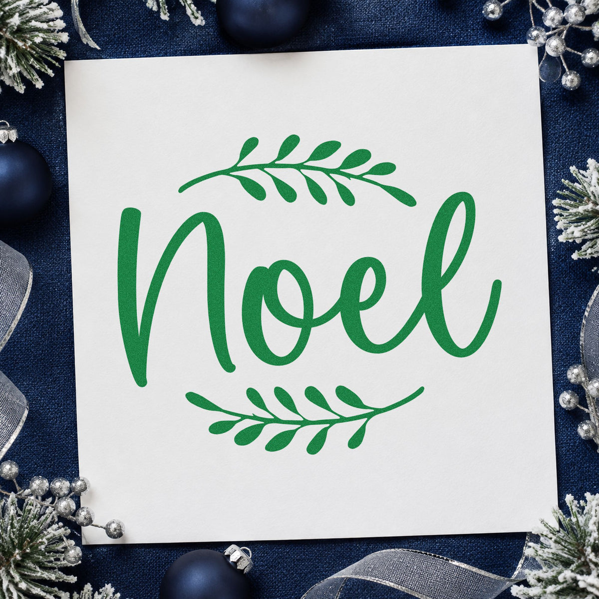 Noel With Leafy Sprigs craft stamp imprint in green ink on a handmade project, one idea being one word gift tags.