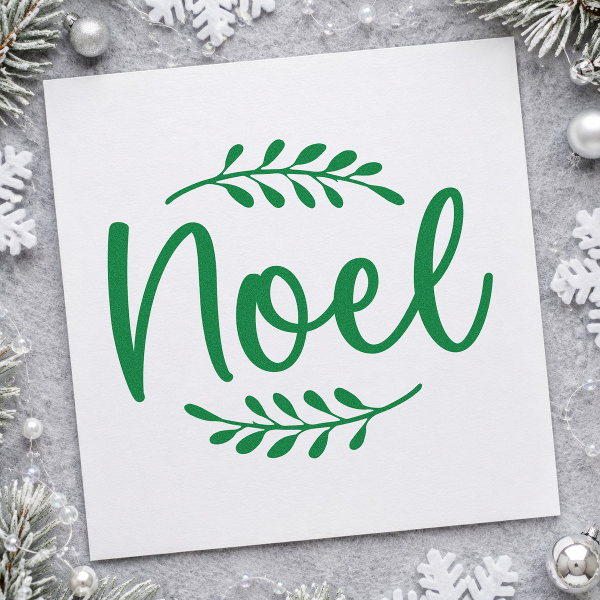 Noel With Leafy Sprigs craft stamp imprint in green ink on a handmade project, one idea being reception sign cards.