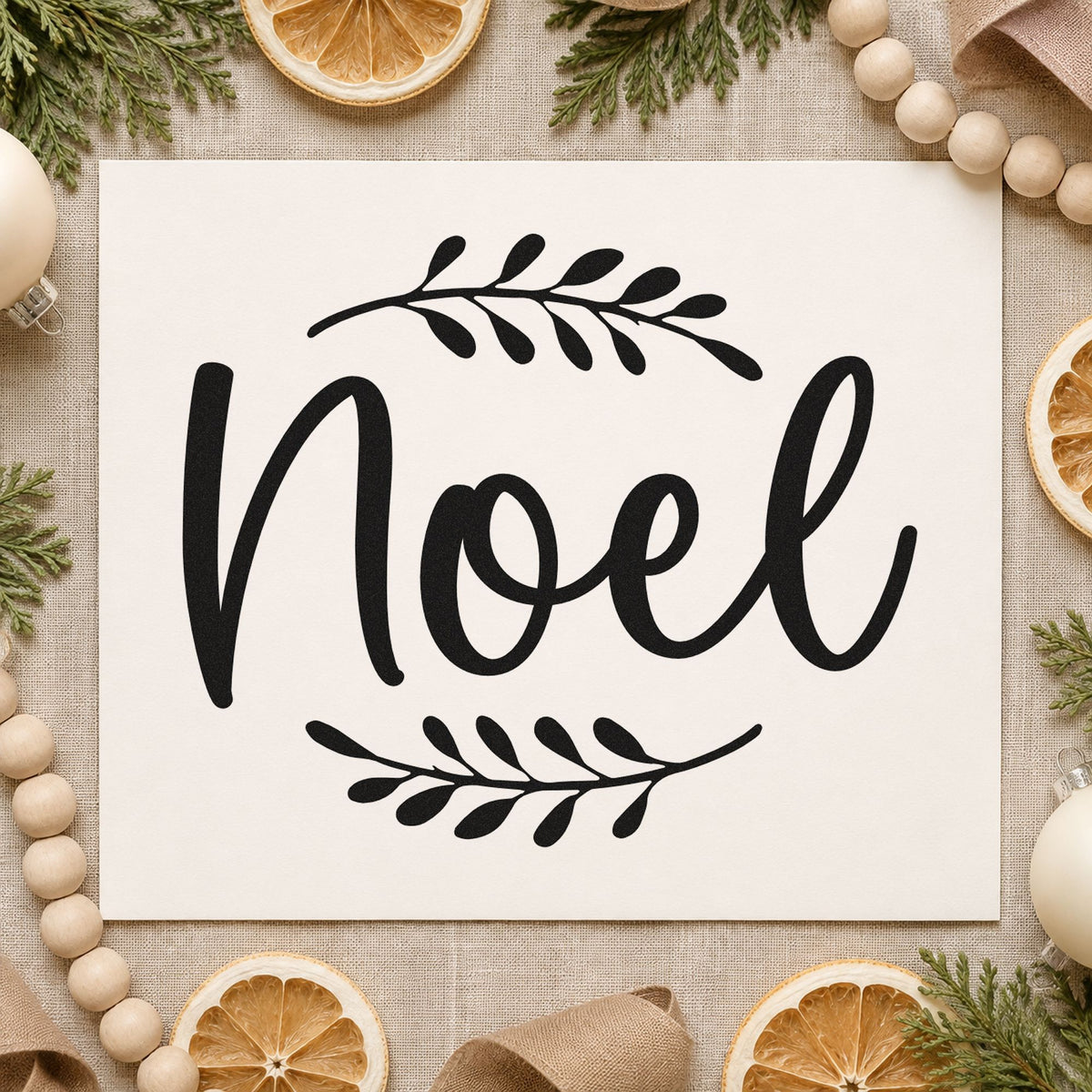 Noel With Leafy Sprigs rubber stamp printed in black ink, ready for sprigs flanking cards and similar paper crafts.