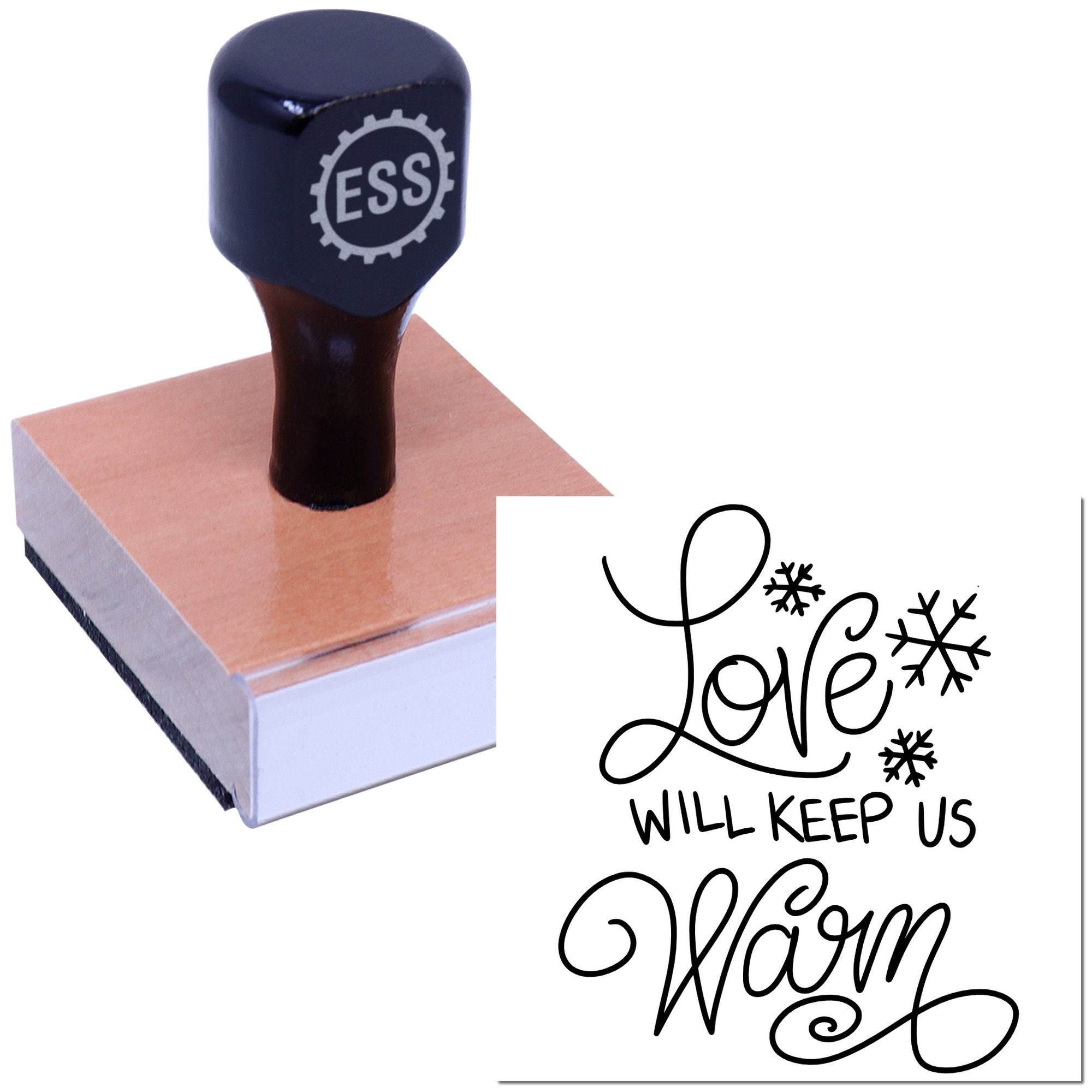 Dark navy ESS stamp and seal on pink wood block, with black Love will keep us warm script and snowflake accents.